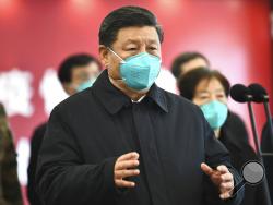 In this Tuesday, March 10, 2020, photo released by China's Xinhua News Agency, Chinese President Xi Jinping talks by video with patients and medical workers at the Huoshenshan Hospital in Wuhan in central China's Hubei Province. Top Chinese officials secretly determined they were likely facing a pandemic from a novel coronavirus in mid-January, ordering preparations even as they downplayed it in public. Internal documents obtained by the AP show that because warnings were muffled inside China, it took a con