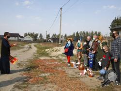 A priest of the Ukrainian Orthodox Church Nazariy, wearing a face mask to protect against coronavirus, blesses family members on the Easter eve near their house in the village of Nove close to capital Kyiv, Ukraine, Saturday, April, 18, 2020. All the Ukrainian churches have been closed for people because of COVID-19 outbreak, and believers wait for the priest right near their houses. For Orthodox Christians, this is normally a time of reflection, communal mourning and joyful release, of centuries-old ceremo