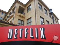 FILE - This Jan. 29, 2010, file photo shows the company logo and view of Netflix headquarters in Los Gatos, Calif. Netflix picked up nearly 16 million global subscribers during the first three months of the year, helping cement its status as one of the world's most essential services in times of isolation or crisis. (AP Photo/Marcio Jose Sanchez, File)