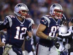 FILE - In this Nov. 13, 2016, file photo, New England Patriots quarterback Tom Brady (12) and tight end Rob Gronkowski head to the sideline during the team's NFL football game against the Seattle Seahawks in Foxborough, Mass. Gronkowski has agreed to a reunion with Brady. The agent for the retired New England star confirmed Tuesday, April 21, 2020, that pending completion of a physical, Gronkowski has agreed to play for the Tampa Bay Buccaneers, who are acquiring his rights from the Patriots. (AP Photo/Char