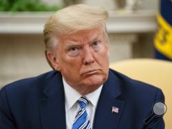 President Donald Trump listens during a meeting with Gov. Ron DeSantis, R-Fla., on the coronavirus response, in the Oval Office of the White House, Tuesday, April 28, 2020, in Washington. (AP Photo/Evan Vucci)