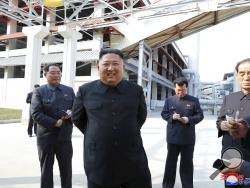 ADDING CITY - In this Friday, May 1, 2020, photo provided by the North Korean government, North Korean leader Kim Jong Un, center, visits a fertilizer factory in Sunchon, South Pyongan province, near Pyongyang, North Korea. Kim made his first public appearance in 20 days as he celebrated the completion of the fertilizer factory, state media said Saturday, May 2, 2020, ending an absence that had triggered global rumors that he may be seriously ill. Independent journalists were not given access to cover the e