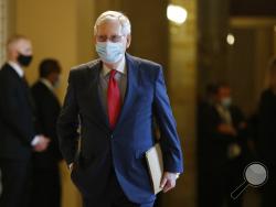 Senate Majority Leader Mitch McConnell of Ky., wears a face mask to protect against the spread of the new coronavirus as he walks to the Senate chamber after meeting with Vice President Mike Pence and Treasury Secretary Steve Mnuchin on Capitol Hill in Washington, Tuesday, May 19, 2020. (AP Photo/Patrick Semansky)