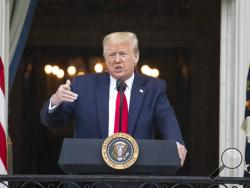 In this Friday, May 22, 2020, photo, President Donald Trump speaks during a "Rolling to Remember Ceremony," to honor the nation's veterans and POW/MIA, from the Blue Room Balcony of the White House in Washington. Trump booked back-to-back Memorial Day appearances despite the coronavirus pandemic, at Arlington National Cemetery and at a historic fort in Baltimore. (AP Photo/Alex Brandon)
