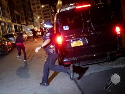 A protester runs as he is chased by police on Monday, June 1, 2020, in New York. Protests were held throughout the city over the death of George Floyd, a black man in police custody in Minneapolis who died after being restrained by police officers on Memorial Day. (AP Photo/Wong Maye-E)