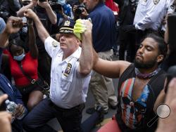 Chief of Department of the New York City Police, Terence Monahan, takes a knee with activists as protesters paused while walking in New York, Monday, June 1, 2020. Demonstrators took to the streets of New York to protest the death of George Floyd, who died May 25 after he was pinned at the neck by a Minneapolis police officer. (AP Photo/Craig Ruttle)