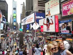 FILE - In this June 20, 2019, file photo, tourists visit Times Square in New York. After three months of a coronavirus crisis followed by protests and unrest, New York City is trying to turn a page when a limited range of industries reopen Monday, June 8, 2020. (AP Photo/Mark Lennihan, File)