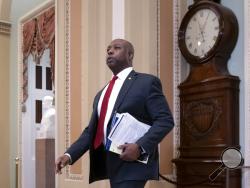 FILE - In this Jan. 21, 2020, file photo, Sen. Tim Scott, R-S.C., arrives at the Senate at the Capitol in Washington. Senate Republicans are proposing changes to police procedures and accountability with an enhanced use-of-force database, restrictions on chokeholds and new commissions to study law enforcement and race, according to a draft obtained by The Associated Press. The package is set to be introduced Wednesday by Scott, the GOP's lone black Republican, and a task force of GOP senators assembled by R