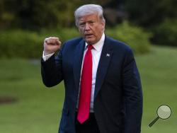 President Donald Trump pumps his fist as he walks on the South Lawn after arriving on Marine One at the White House, Thursday, June 25, 2020, in Washington. Trump is returning from Wisconsin. (AP Photo/Alex Brandon)