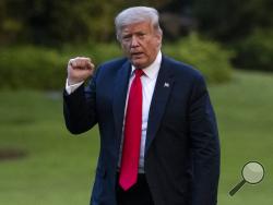 President Donald Trump pumps his fist as he walks on the South Lawn after arriving on Marine One at the White House, Thursday, June 25, 2020, in Washington. Trump is returning from Wisconsin. (AP Photo/Alex Brandon)