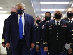  AP Photo/Patrick Semansky President Donald Trump wears a mask as he walks down the hallway during his visit to Walter Reed National Military Medical Center in Bethesda, Md., Saturday.
