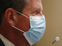 Georgia Gov. Brian Kemp looks on during a coronavirus briefing at the Capitol Friday, July 17, 2020, in Atlanta. Kemp sued the city of Atlanta over its face-mask requirement just after President Donald Trump arrived in the city without wearing a mask, Mayor Keisha Lance Bottoms said Friday. (AP Photo/John Bazemore)