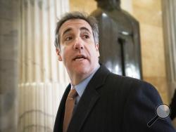 FILE - In this March 6, 2019 file photo, Michael Cohen, President Donald Trump's former lawyer, returns to testify on Capitol Hill in Washington. President Donald Trump's former personal lawyer has sued Attorney General William Barr and the Bureau of Prisons director, saying he's being unjustly held behind bars to stop him from finishing a book that criticizes Trump. The lawsuit on behalf of Michael Cohen was filed late Monday, July 20, 2020 in Manhattan federal court, (AP Photo/J. Scott Applewhite, File)