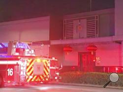 In this image made from video, fire engine is seen outside Chinese consulate in Houston, Tuesday, July 21, 2020. Media reports in Houston said that authorities had responded to reports of a fire at the consulate. Witnesses said that people were burning paper in what appeared to be trash cans, the Houston Chronicle reported, citing police.(KTRK via AP)