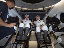 NASA astronauts Robert Behnken, left, and Douglas Hurley are seen inside the SpaceX Crew Dragon Endeavour spacecraft onboard the SpaceX GO Navigator recovery ship shortly after having landed in the Gulf of Mexico off the coast of Pensacola, Fla., Sunday, Aug. 2, 2020. The Demo-2 test flight for NASA's Commercial Crew Program was the first to deliver astronauts to the International Space Station and return them safely to Earth onboard a commercially built and operated spacecraft. Behnken and Hurley returned 
