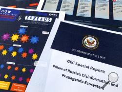 Pages from the U.S. State Department's Global Engagement Center report released on Aug. 5, 2020, are seen in this photo. The State Department says Russia is using a well-developed online operation that includes a loose collection of proxy websites to stir up confusion around the coronavirus by amplifying conspiracy theories and misinformation. The department detailed a Russian-backed misinformation cycle that spreads false information online through state officials and state-funded media reports, by infiltr
