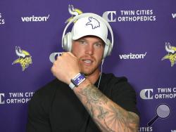 This photo taken Aug. 5, 2020, during a Zoom interview with reporters, Vikings tight end Kyle Rudolph, displays the proximity tracking device that players and staff around the NFL are wearing at team facilities as part of COVID-19 protocols.