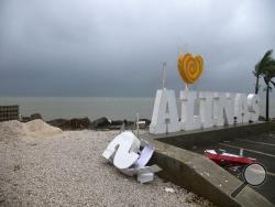 Remnants of a city sign lay on the beach damaged by Tropical Storm Laura in Salinas, Puerto Rico, Saturday, Aug. 22, 2020. Laura began flinging rain across Puerto Rico and the Virgin Islands on Saturday morning and was expected to drench the Dominican Republic, Haiti and parts of Cuba during the day on its westward course. (AP Photo/Carlos Giusti)
