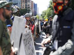 Opposing rallies battle with mace, paint balls and rocks near Justice Center in downtown Portland Saturday, August 22, 2020. Dueling demonstrations in Portland by right-wing and left-wing protesters have turned violent near a county building that's been the site of numerous recent protests. (Brooke Herbert/The Oregonian via AP)/The Oregonian via AP)/The Oregonian via AP)/The Oregonian via AP)
