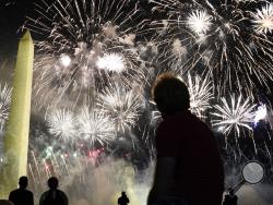 People watch fireworks near the Washington Monument on the fourth day of the Republican National Convention, Thursday, Aug. 27, 2020, in Washington. (AP Photo/Andrew Harnik)