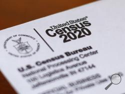 FILE - This Sunday, April 5, 2020, photo shows an envelope containing a 2020 census letter mailed to a U.S. resident in Detroit. The U.S. Census Bureau has spent much of the past year defending itself against allegations that its duties have been overtaken by politics. With a failed attempt by the Trump administration to add a citizenship question, the hiring of three political appointees with limited experience to top positions, a sped-up schedule and a directive from President Donald Trump to exclude undo