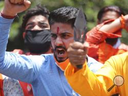 FILE - In this Wednesday, June 17, 2020, file photo, activists of Rashtriya Bajrang Dal shout slogans during a protest against the Chinese government in Jammu, India. As the escalating and bitter military standoff between India and China protracts following their bloodiest confrontation in decades in the Ladakh region in 2020, experts warn the two nuclear-armed countries can unintentionally slide into a war over the roof of the world. Both the Asian giants have accused the other of fresh provocations, inclu