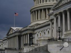 FILE - In this Aug. 3, 2020, file photo dark clouds and heavy rain sweep over the U.S. Capitol in Washington. At least a government shutdown is off the table. But as lawmakers straggle back to Washington for an abbreviated pre-election session, hopes are fading for a pandemic relief bill, or much else. (AP Photo/J. Scott Applewhite, File)