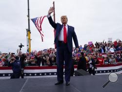 President Donald Trump waves as he arrives for a campaign rally at MBS International Airport, Thursday, Sept. 10, 2020, in Freeland, Mich. (AP Photo/Evan Vucci)