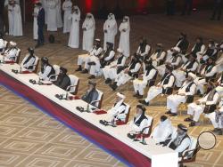 Taliban negotiator Abbas Stanikzai, fifth right, with his delegation attend the opening session of the peace talks between the Afghan government and the Taliban in Doha, Qatar, Saturday, Sept. 12, 2020. (AP Photo/Hussein Sayed)