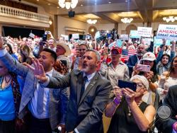 Supporters react as President Donald Trump speaks at a Latinos for Trump Coalition roundtable at Arizona Grand Resort & Spa, Monday, Sept. 14, 2020, in Phoenix. (AP Photo/Andrew Harnik)