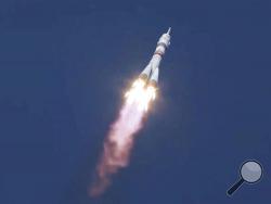 In this image made from video footage released by Roscosmos Space Agency, the Soyuz-2.1a rocket booster with the Soyuz MS-17 space ship carrying a new crew to the International Space Station (ISS), blasts off at the Russian leased Baikonur cosmodrome, Kazakhstan, Wednesday, Oct. 14, 2020. A trio of space travelers has launched successfully to the International Spce Station, for the first time using a fast-track maneuver to reach the orbiting outpost in just three hours. NASA's Kate Rubins and Sergey Ryzhiko