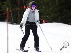 FILE - In this May 27, 2020, file photo, a skier wears a face covering while negotiating the slope at the reopening of Arapahoe Basin Ski Resort, which closed in mid-March to help in the effort to stop the spread of the new coronavirus, in Keystone, Colo. Roughly seven months after the coronavirus cut the ski season short at the height of spring break, resorts across the U.S. and Canada are slowly picking up the pieces and figuring out how to safely reopen this winter. (AP Photo/David Zalubowski, File)