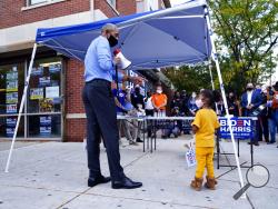 Former President Barack Obama speaks speaks to volunteers outside of a Democratic Voter Activation Center as he campaigns for Democratic presidential candidate former Vice President Joe Biden, Wednesday, Oct. 21, 2020, in Philadelphia, as a child watches. (AP Photo/ Matt Slocum)