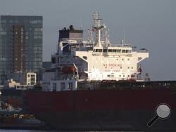 The Nave Andromeda oil tanker is docked next to the Queen Elizabeth II Cruise Terminal in Southampton, England, Monday, Oct. 26, 2020. The U.K. military seized control of the oil tanker that dropped anchor in the English Channel after reporting it had seven stowaways on board who had become violent. (Andrew Matthews/PA Wire via AP)