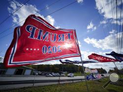 Trump campaign banners wave in the wind along Route 8 in Middlesex Township, Pa., in conservative Butler County on Thursday, Oct. 15, 2020. To win Pennsylvania, President Donald Trump needs blowout victories and historic turnout in conservative strongholds across the state. (AP Photo/Gene J. Puskar)