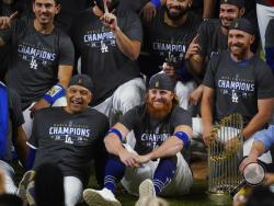 Los Angeles Dodgers manager Dave Roberts and third baseman Justin Turner pose for a group picture after the Dodgers defeated the Tampa Bay Rays 3-1 in Game 6 to win the baseball World Series, Tuesday, Oct. 27, 2020, in Arlington, Texas. (AP Photo/Eric Gay)