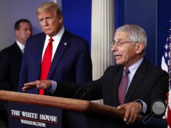 FILE - In this April 22, 2020, file photo, President Donald Trump listens as Dr. Anthony Fauci, director of the National Institute of Allergy and Infectious Diseases, speaks about the coronavirus in the James Brady Press Briefing Room of the White House in Washington. (AP Photo/Alex Brandon, File)