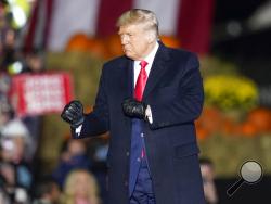 President Donald Trump dances as he leaves a campaign stop, Saturday, Oct. 31, 2020, at the Butler County Regional Airport in Butler, Pa. (AP Photo/Keith Srakocic)