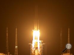 A Long March-5 rocket carrying the Chang'e 5 lunar mission lifts off at the Wenchang Space Launch Center in Wenchang in southern China's Hainan Province, early Tuesday, Nov. 24, 2020. China launched an ambitious mission on Tuesday to bring back material from the moon's surface for the first time in more than 40 years — an undertaking that could boost human understanding of the moon and of the solar system more generally. (AP Photo/Mark Schiefelbein)