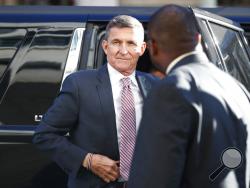 FILE - President Donald Trump's former National Security Advisor Michael Flynn arrives at federal court in Washington, Tuesday, Dec. 18, 2018. President Donald Trump has pardoned Michael Flynn, taking direct aim in the final days of his administration at a Russia investigation that he has long insisted was motivated by political bias. Trump announced the pardon on Wednesday, Nov. 25, 2020 calling it his “Great Honor.” (AP Photo/Carolyn Kaster)