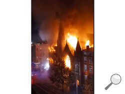 Firefighters work to extinguish a fire that erupted from a building next to Middle Collegiate Church on Saturday, Dec. 5, 2020 in New York. The historic 19th century church in lower Manhattan was gutted by a massive fire early Saturday that sent flames shooting through the roof. (Duke Todd via AP)