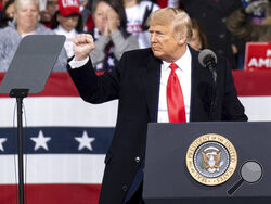 President Donald Trump addresses the crowd at a rally for U.S. Senators Kelly Loeffler, R-Ga., and David Perdue, R-Ga., who are both facing runoff elections Saturday, Dec. 5, 2020, in Valdosta, Ga. (AP Photo/Ben Gray)