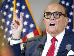 FILE - Former Mayor of New York Rudy Giuliani, a lawyer for President Donald Trump, speaks during a news conference at the Republican National Committee headquarters, Thursday Nov. 19, 2020, in Washington. President Donald Trump says his personal attorney Rudy Giuliani has tested positive for coronavirus.The president on Sunday, Dec. 6, 2020 confirmed in a tweet that Giuliani had tested positive for the virus. Giuliani has traveled extensively to battleground states in effort to help Trump subvert his elect