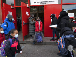 Students arrive at P.S. 134 Henrietta Szold Elementary School, Monday, Dec. 7, 2020, in New York. Public schools reopened for in-school learning Monday after being closed since mid-November. (AP Photo/Mark Lennihan)