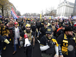 Supporters of President Donald Trump who are wearing attire associated with the Proud Boys attend a rally at Freedom Plaza, Saturday, Dec. 12, 2020, in Washington. (AP Photo/Luis M. Alvarez)