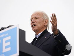 President-elect Joe Biden speaks at a drive-in rally for Georgia Democratic candidates for U.S. Senate Raphael Warnock and Jon Ossoff, Tuesday, Dec. 15, 2020, in Atlanta. (AP Photo/Patrick Semansky)
