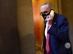 Senate Minority Leader Sen. Chuck Schumer of N.Y., walks on Capitol Hill in Washington, Tuesday, Dec. 15, 2020. (AP Photo/Susan Walsh)