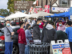 Patrons at the popular Paula's Pancake House on Hwy 246 enjoy new outside seating arrangements brought about by COVID-19 on Oct. 10, 2020, in Solvang, California. It was almost two weeks ago that the popular California tourist town of Solvang made headlines when it said it wouldn't enforce Gov. Gavin Newsom's tough new stay-at-home orders. But that was a week before a new City Council took over and told everyone to obey the rules to save lives. (George Rose/Santa Ynez Valley Star via AP)