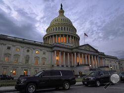 Dusk falls over the Capitol, Monday, Dec. 21, 2020, in Washington. Congressional leaders have hashed out a massive, year-end catchall bill that combines $900 billion in COVID-19 aid with a $1.4 trillion spending bill and reams of other unfinished legislation on taxes, energy, education and health care. (AP Photo/Jacquelyn Martin)