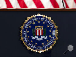 FILE - In this June 14, 2018, file photo, the FBI seal is seen before a news conference at FBI headquarters in Washington. The U.S. government on Tuesday, Jan. 5, 2021, said a devastating hack of federal agencies is “likely Russian in origin” and said the operation appeared to be an “intelligence gathering” effort. The assessment was disclosed in a rare public statement from the FBI and other investigative agencies. (AP Photo/Jose Luis Magana, File)